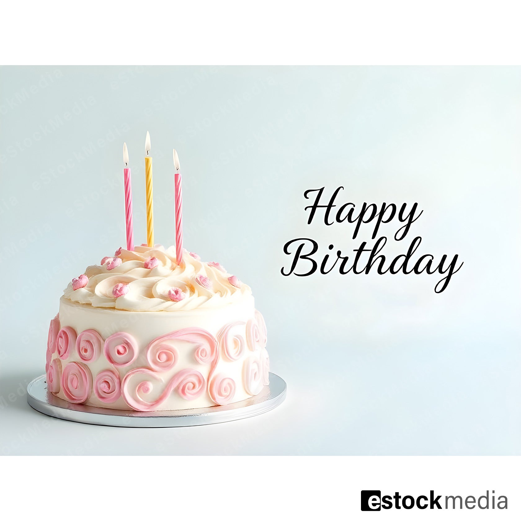Happy Birthday cake with white frosting, pink swirl decorations and colorful candles